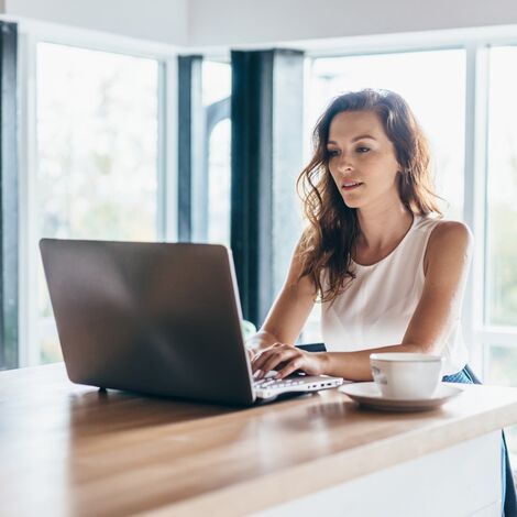 Woman reviewing 3D building models at home with the help of Avalon Studio.