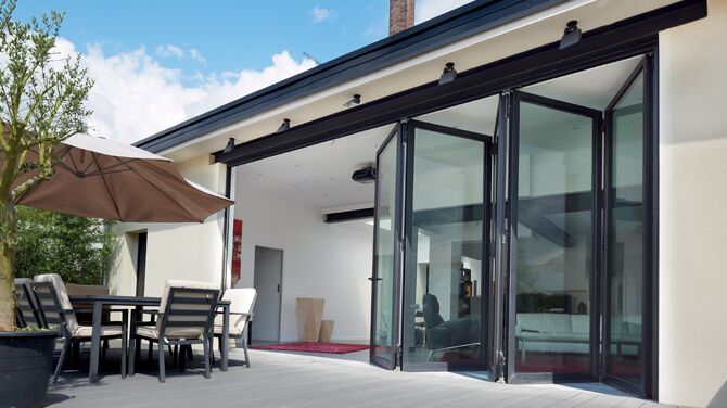 Outside view of opened folding door system featured in a private home.